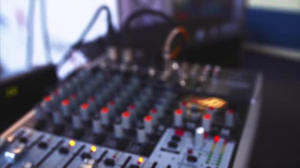 Close view of blurred sound console and closeup of two microphones — Stock Video