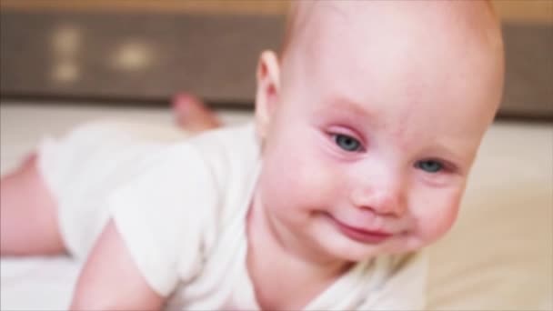 Extreme closeup portrait of adorable blue-eyed 6 months old baby boy — Stock Video