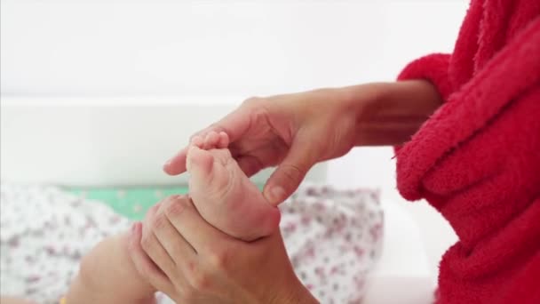 Mother Massaging Son Foot Changing Table Swimming — Stock Video