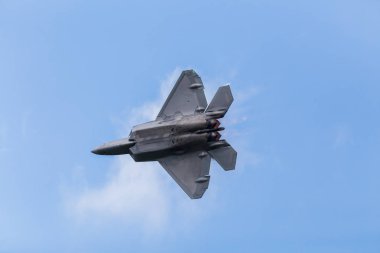 Cloud forming off the wings of the USAF Raptor clipart