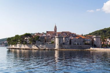 Korcula old town juts out into the Peljesac Channel clipart