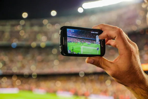 Supporter football team recording goal with mobile phone camera. — Stock fotografie