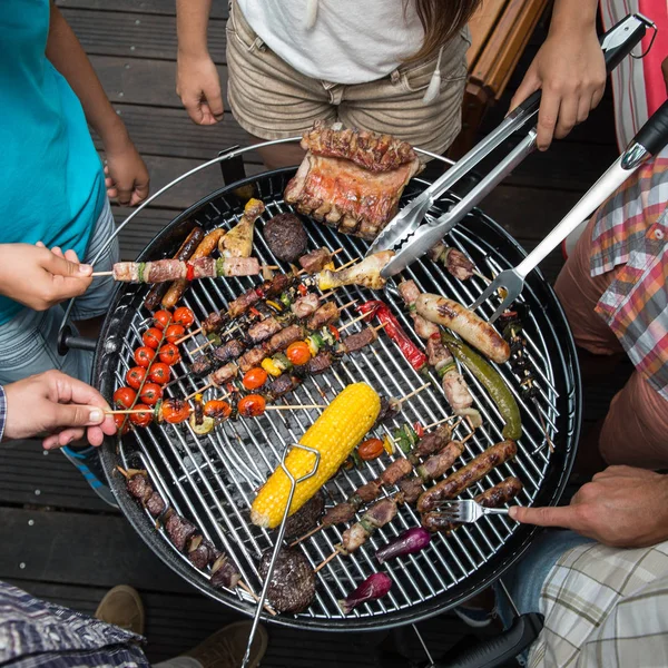 Bovenaanzicht van vriend handen eten, barbecue Tuinfeestje serveren — Stockfoto