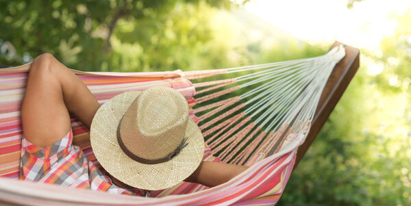 Man Sleeping Relaxing With hat on face In Hammock
