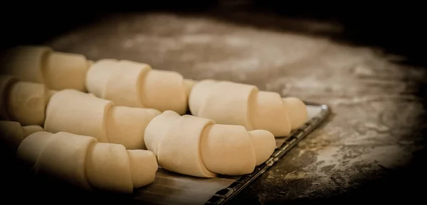 Not baked french croissants on oven-tray — Stock Photo, Image