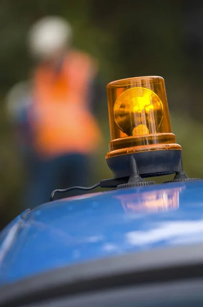 Orange flashing and revolving light on top services vehicle