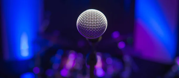 Microphone on stage against a background of auditorium