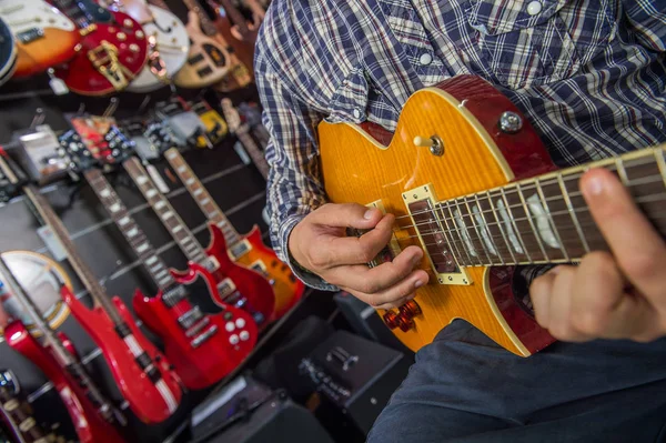 Joven tocando la guitarra en una tienda —  Fotos de Stock