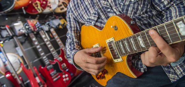 Joven tocando la guitarra en una tienda —  Fotos de Stock