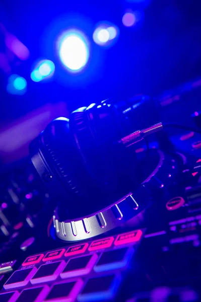 Dj Mixer with headphones at a nightclub — стоковое фото