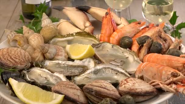 Assiette de fruits de mer frais avec moules de homard et huîtres sur la table tournante — Video