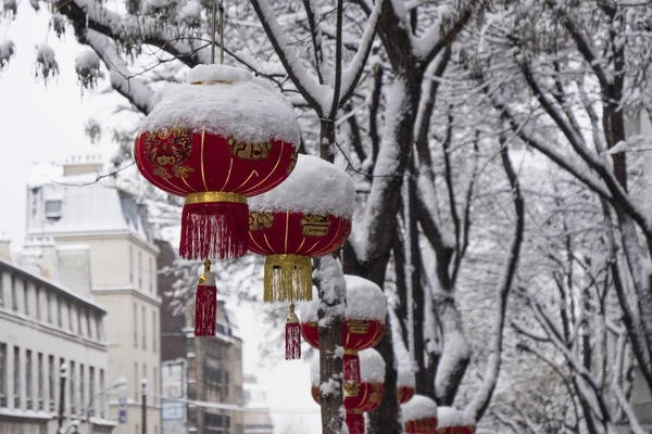 Christmas china tree covered with snow near the eiffel tower in