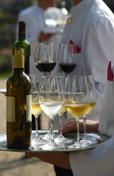 Waiters are serving vine at a wedding outdoor party