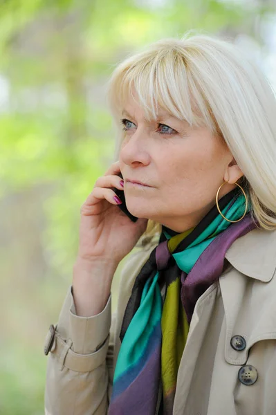 Senior woman reflective phoning — Stock Photo, Image