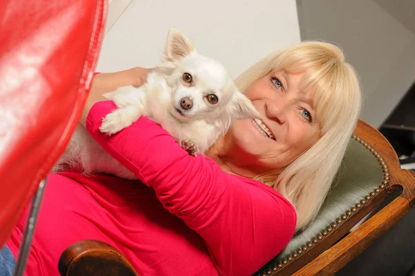 Mulher madura com seu cão em casa — Fotografia de Stock