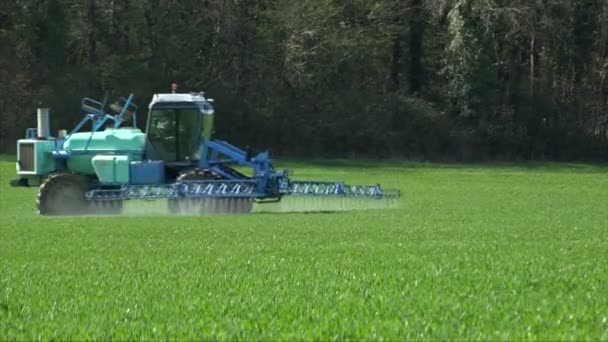 Agriculture fertilizer working on farming field, agriculture machinery working on cultivated field and spraying pesticide — Stock Video