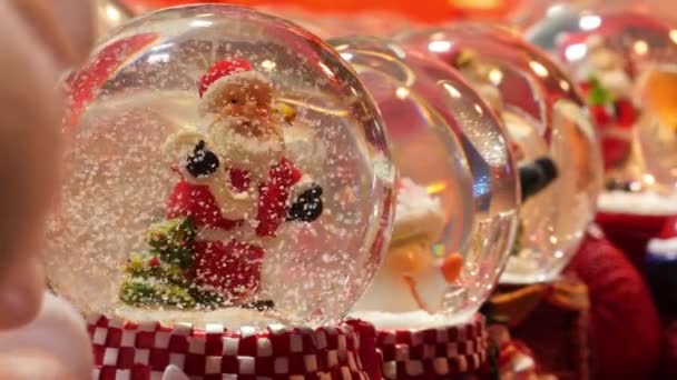 Paris, France - December 11, 2019:Raw of small snow globes Santa Claus sold in Christmas market, Paris — Stock Video
