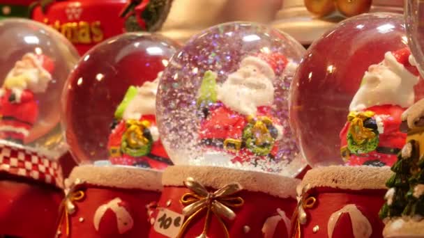 Paris, Frankrike - 11 december 2019: Raw of small snow gloes Santa Claus såld på julmarknaden, Paris — Stockvideo