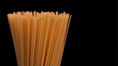 Spaghetti rotating on black background