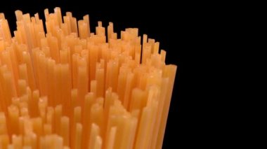 Spaghetti rotating on black background