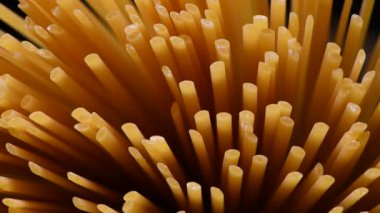 Spaghetti rotating on black background