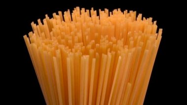 Spaghetti rotating on black background