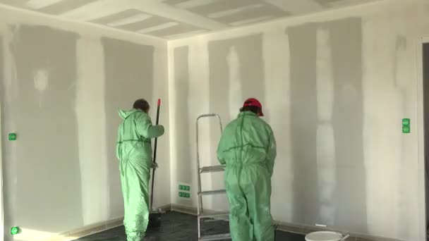 Time lapse two painters painting wall whith and ceiling in new house — Stock Video