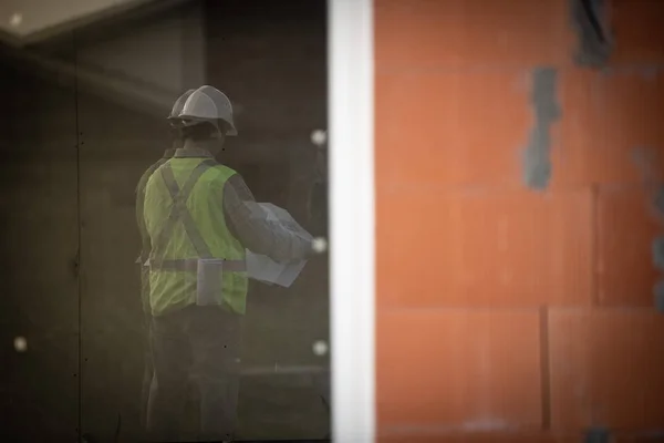 Професійний інженер-архітектор робітник з захисним шоломом на будівельному майданчику будинку — стокове фото