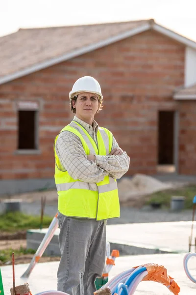 Ingeniero profesional arquitecto trabajador con casco protector en el edificio de la casa sitio de construcción de fondo —  Fotos de Stock