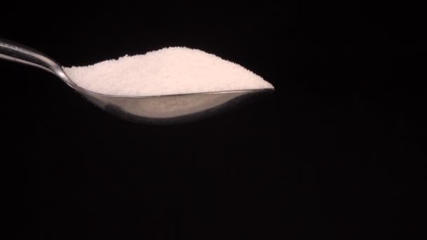 Close up White sugar Droping from stainless on black background — Stock Video