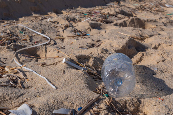 Plastic bottle on the beach, pollution