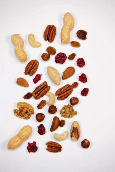 Mixed nuts and dried fruits in wooden bowl on white background, copy space — Stock Photo, Image