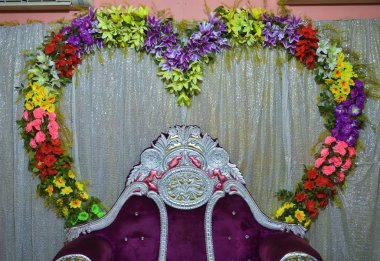 White Heart chairs with the background of heart shape flowers for valentine day.