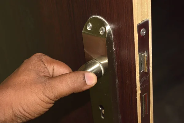 things and objects in everyday life and human life through which germs and viruses spread, door handle in an apartment in a room or house with hand and finger