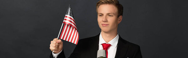 smiling emotional man with american flag on black background