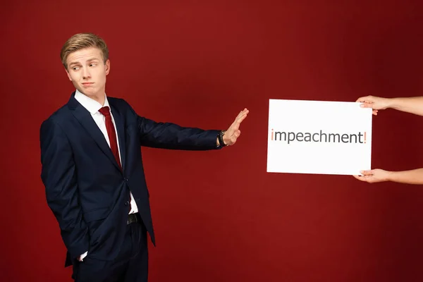 Emotional Man Showing Gesture White Card Impeachment Lettering Red Background — Stock Photo, Image