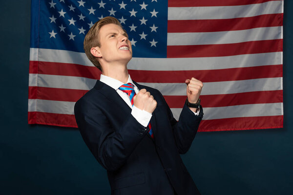 excited man showing yes gesture on american flag background
