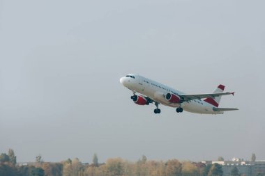 Flight departure of commercial plane above runway clipart