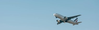 Flight departure of airplane in blue sky with copy space, panoramic shot  clipart