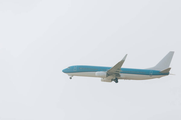 Flight departure of airplane with cloudy sky at background