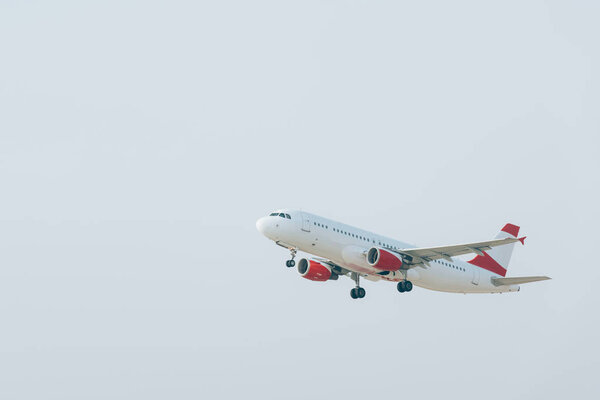 Aeroplane taking off with cloudy sky at background