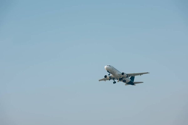 Jet plane taking off with blue sky at background