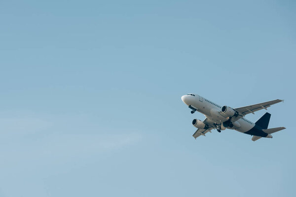 Commercial jet plane landing in blue sky 