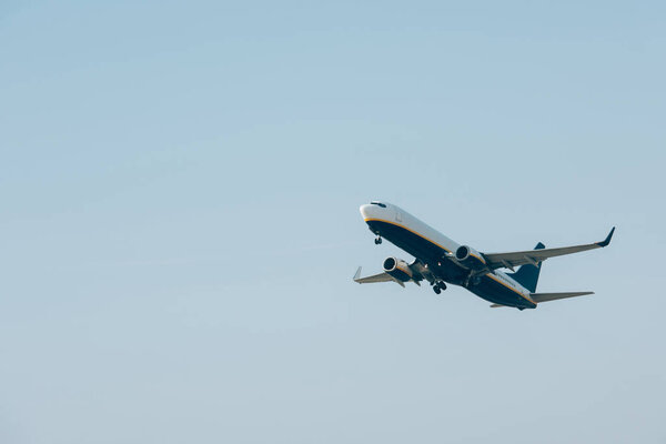 Jet plane taking off in blue sky