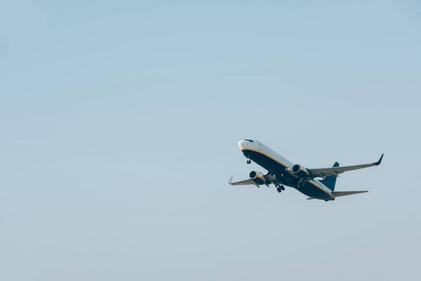 Flight departure of commercial plane in blue sky 