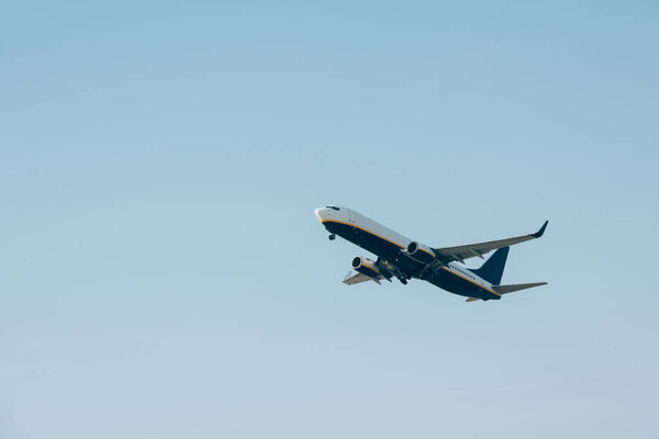 Low angle view of airplane departure in blue sky with copy space