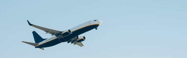 Commercial jet plane taking off in blue sky, panoramic shot 
