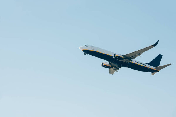 Low angle view of airplane landing in clear sky