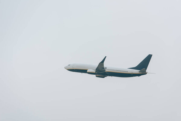 Low angle view of airplane taking off in cloudy sky