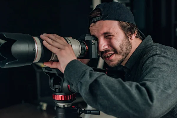 Videographer with camera working in photo studio — Stock Photo